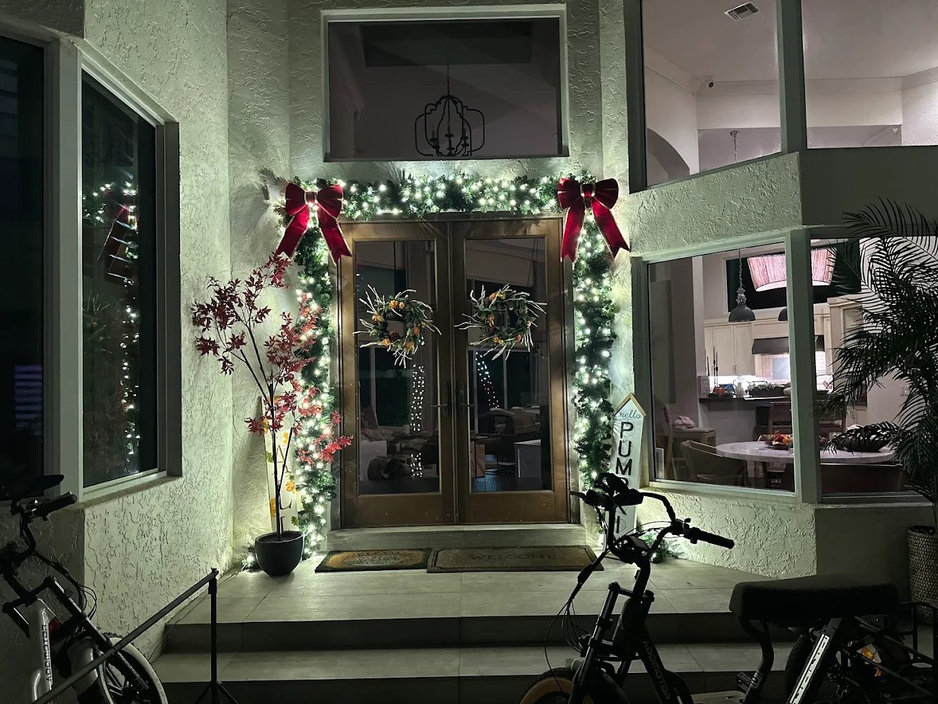 Delray Beach home with holiday roofline lighting and wrapped palms
